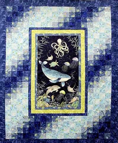 Quilt center features a fabric panel with a whale, octopus, dolphins, sea horses, sea turtles, manta rays, jelly fish and star fish.