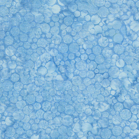 This batik cotton fabric features tonal (reads as a solid) light blue bubbles.
