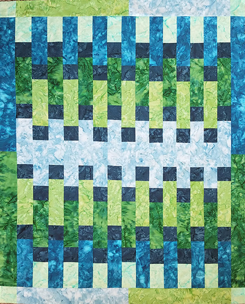 This quilt is made from long rectangles in blues and greens with dark blue accent squares.