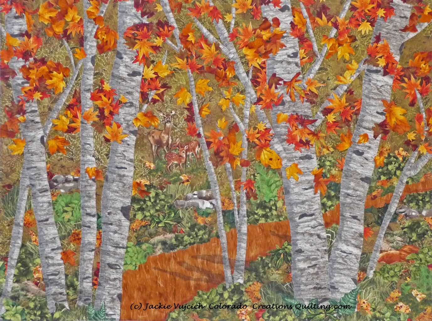 Among the Trees quilt shows a dirt path among aspen trees with lush foliage and gold/rust leaves.  A family of dear are grazing in the meadow available at Colorado Creations Quilting