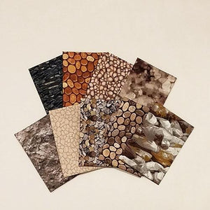 This fat quarter bundle has a selection of rock cotton fabrics from pebbles to boulders in shades of brown and gray
