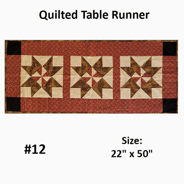 This quilted runner featuring pieced star blocks in shades of red and brown. Designed by Jackie Vujcich.