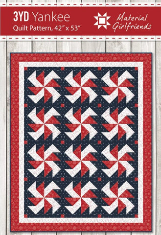 The quilt features red and white star blocks on a navy background with a white inner border and a red outer border. 