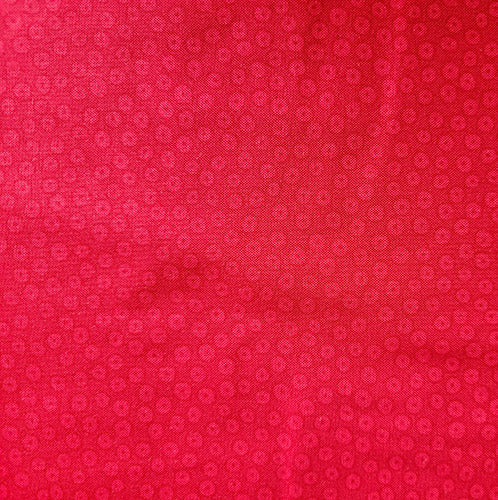 This fabric features red dots on a fire-engine red background. 