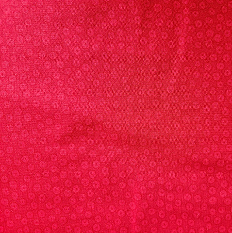 This fabric features red dots on a fire-engine red background. 