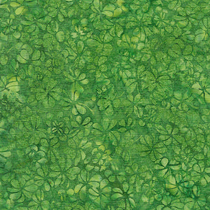 This batik cotton fabric features images of clovers in shades of greens. Available at Colorado Creations Quilting