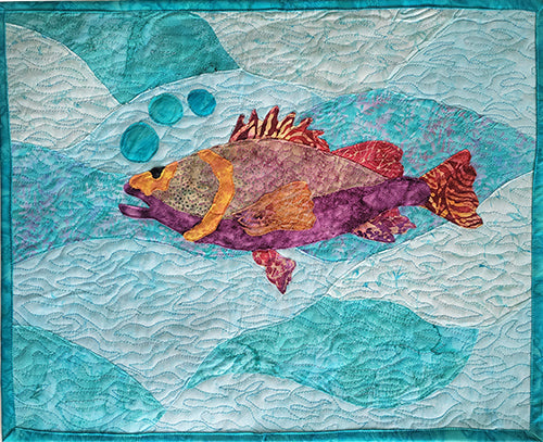 The Mosaic Trout art quilt features a trout on a blue background