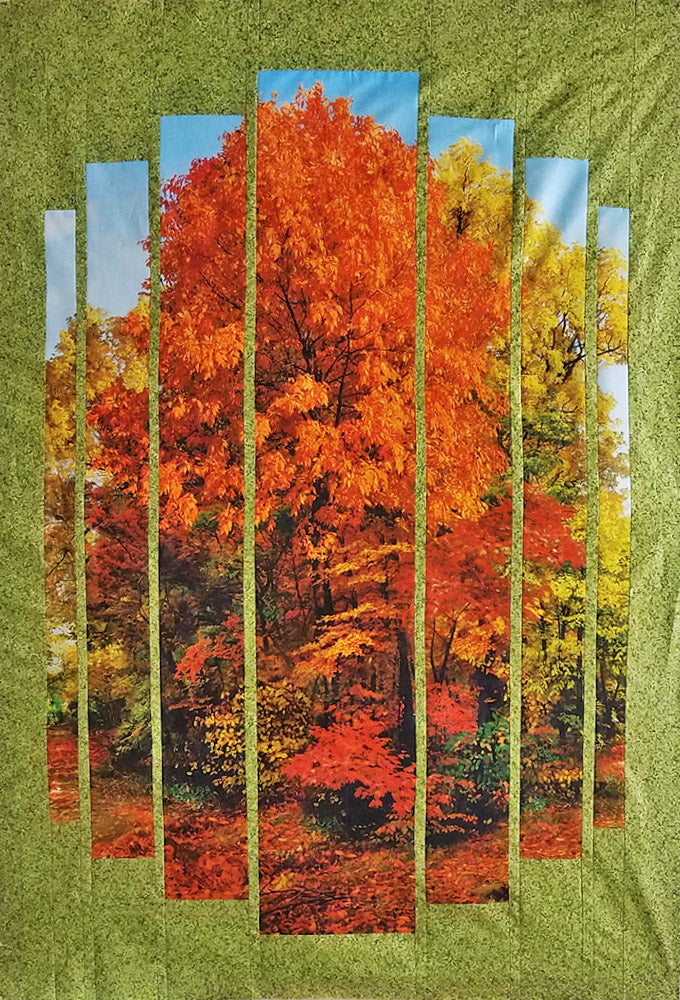 Quilt center features autumn tress of rich oranges and golds with pin-striped green borders