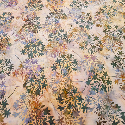 This batik cotton fabric features bunches of flowers in shapes of stars on a tan background. Available at Colorado Creations Quilting