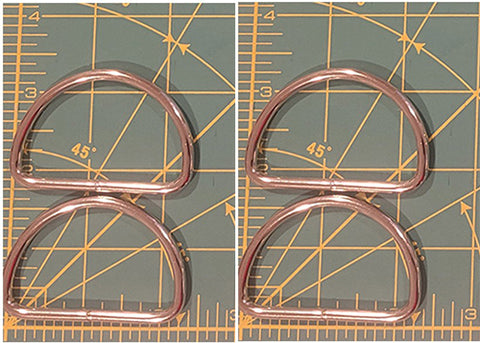 4 metal rings on a grid background