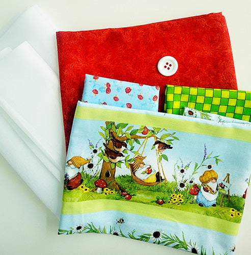 Fabric swatches with colorful designs including a red swatch, blue swatch with mushrooms, and a nature-themed swatch featuring gnomes.