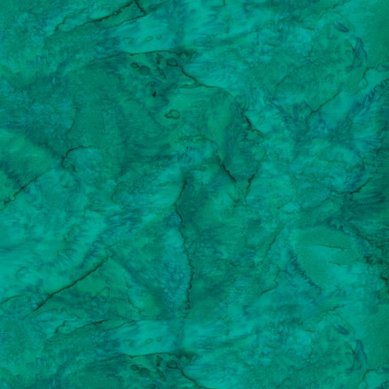 This batik cotton fabric features a deep teal-green color.