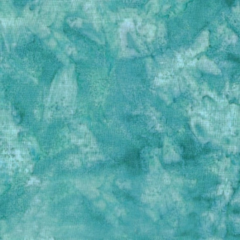 This batik cotton fabric features a rich turquoise-green color suggestive of Carribean seas