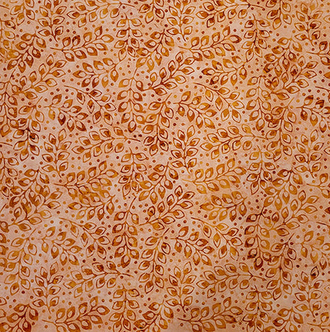 This batik cotton fabric features golden leaves on a tan background. Available at Colorado Creations Quilting