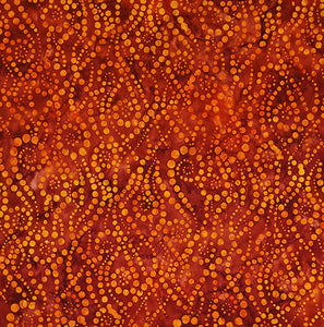 This batik features orange dots on rich cranberry red. Available at Colorado Creations Quilting