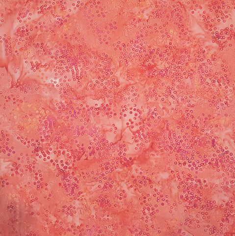 This batik features a tonal coral fabric with dots. Available at Colorado Creations Quilting