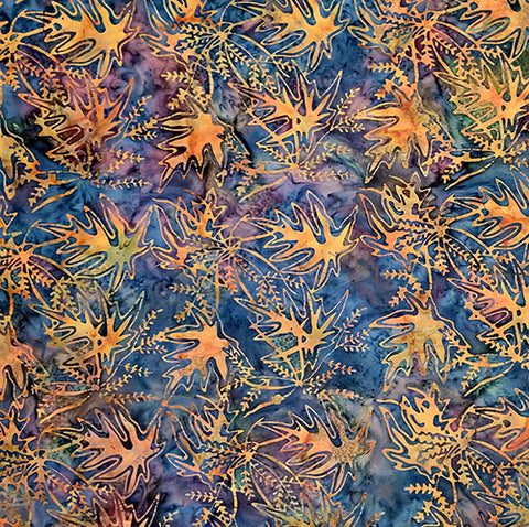 This fabric features  orange leaves on a blue and purple background.