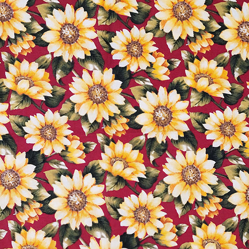 This cotton fabric features yellow sunflowers on a deep red background. Available at Colorado Creations Quilting