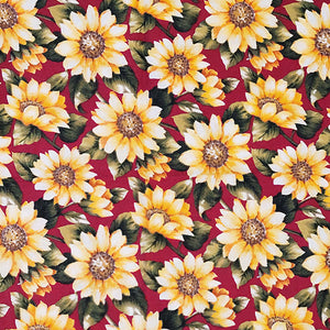 This cotton fabric features yellow sunflowers on a deep red background. Available at Colorado Creations Quilting