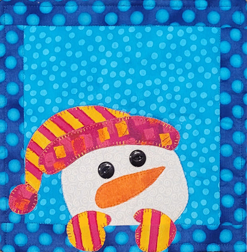 This mug rug is a snowman with a brightly colored hat and mittens.