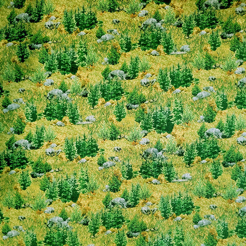 This cotton fabric features evergreen trees in a grassy meadow with a sprinkling of boulders.