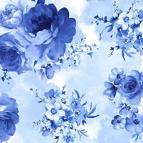 This cotton fabric features large blue flower clusters on light blue background. 