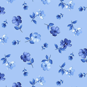 This cotton fabric features small blue flowers tossed on a blue background.