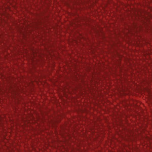 This fabric features a tonal swirling red dots on red batik.  