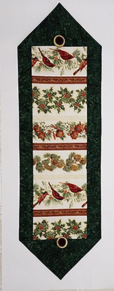 Cardinals surrounded by green border table runner quilt kit available at Colorado Creations Quilting.