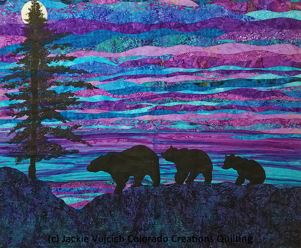 Evening Stroll landscape quilt shows a silhouette of an evergreen tree and three bears strolling in front of a rising moon.  Available at Colorado Creations Quilting