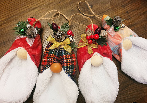 These handmade gnome ornaments are made from yarn, felt, ribbon and various other craft notions.
