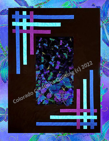Quilt center of blue, green, and purple dragonflies on a background of black with blue purple and turquoise strips woven in the borders.  Pattern available at Colorado Creations Quilting