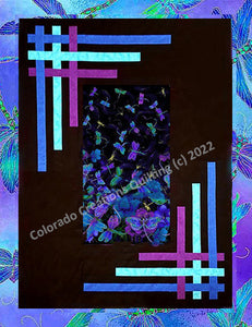 Quilt center of blue, green, and purple dragonflies on a background of black with blue purple and turquoise strips woven in the borders.  Pattern available at Colorado Creations Quilting