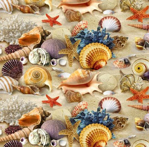 This cotton fabric features brilliantly colored seashells on sand