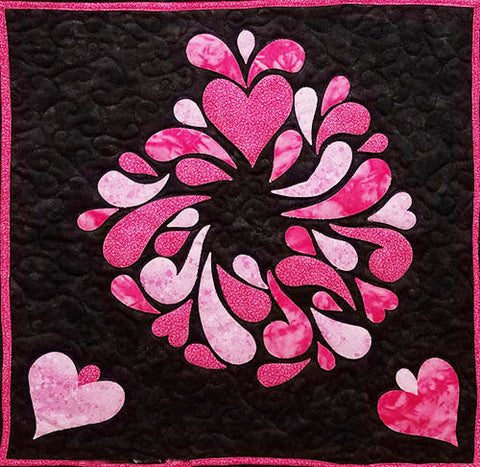 This darling little one of a kind art quilt features a pink heart with pink teardrops gushing from it on a black background. Available at Colorado Creations Quilting