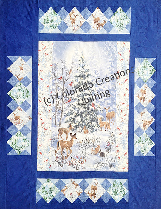 This quilt pattern features a central panel features a snow-covered evergreen tree surrounded by darling forest wildlife like deer, rabbits, cadinals. Multiple borders span outward from there featuring trees and deer blocks set on point. Kit and pattern available at Colorado Creations Quilting 