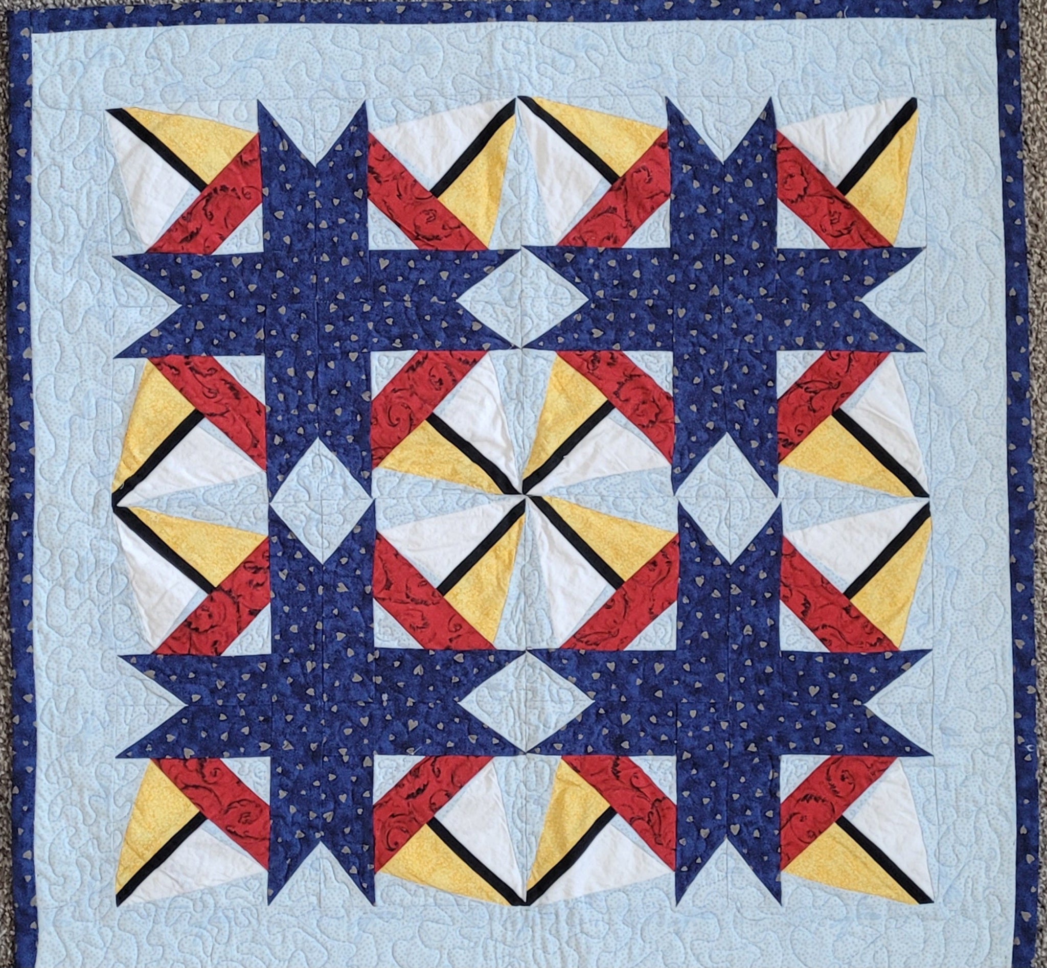 Bright little sailboats abound on a blue background in this quilt done with the paper pieced quilting technique.