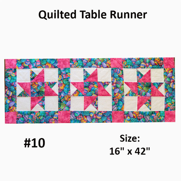 This quilted runner has blocks with stars done in an Easter egg print and pink squares. There is slight damage (stain on the back) which is reflected in the price. Designed by Jackie Vujcich.