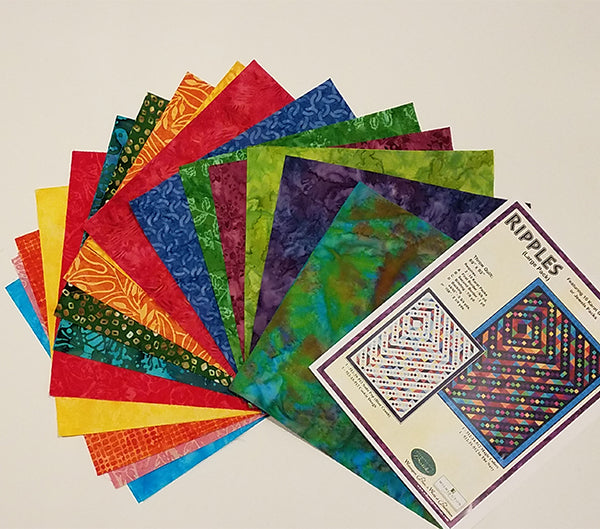 The Ripples quilt kit uses a layer cake (10" squares) in the color of the rainbow shown here.