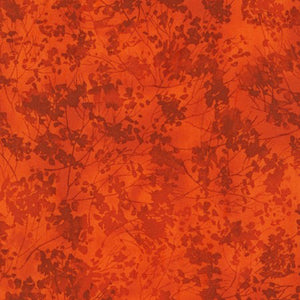 This tonal orange rust cotton fabricf features tree branches