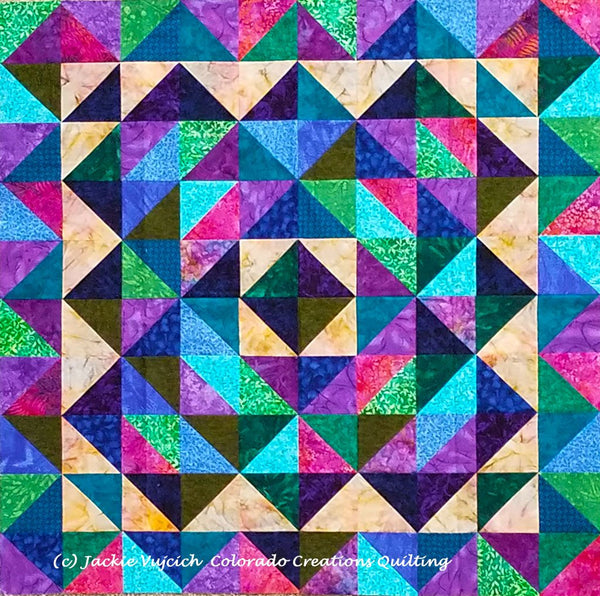 At a Crossroads quilt in blue-purple green colorway using triangles available at Colorado Creations Quilting