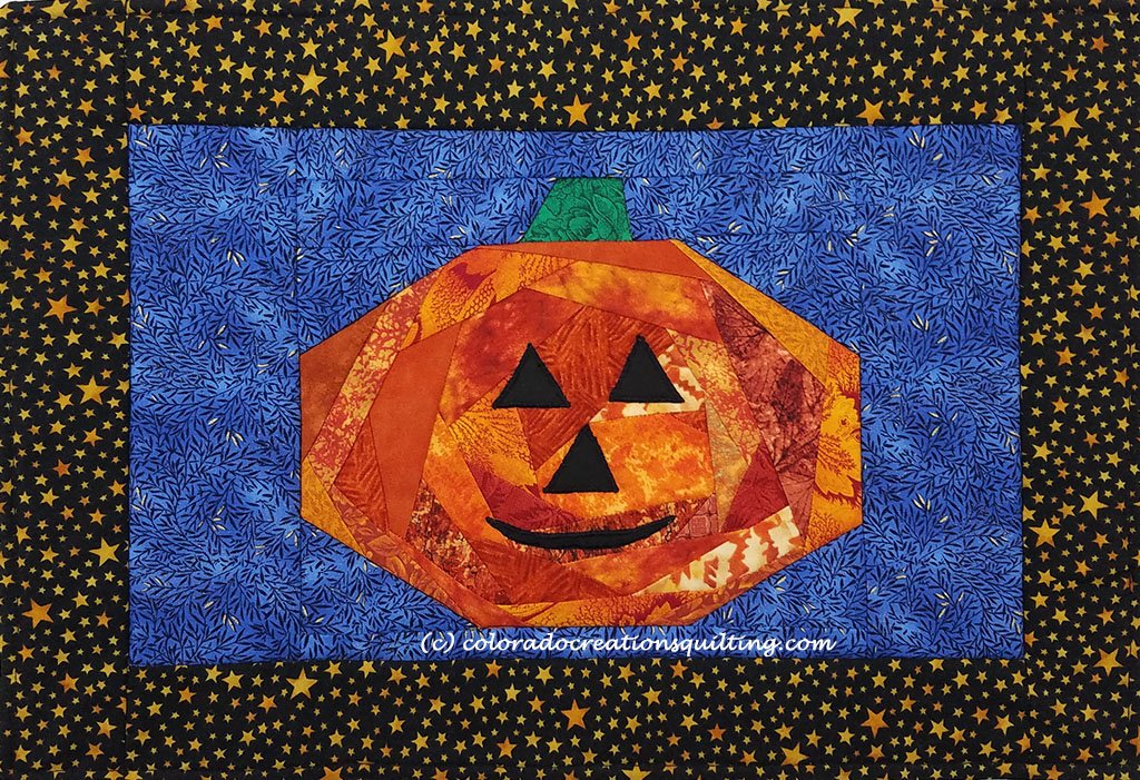Orange Jack O'Lantern on a blue gackgraound placemat