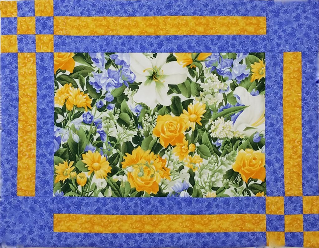 Placemats have a main flower fabric in the center with gold and blue lattice borders on the edges