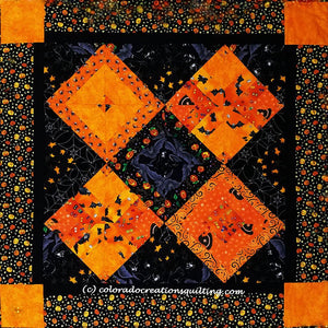 Fright Night quilt has four pieced orange squares on point with alternating black pieced squares available at Colorado Creations Quilting