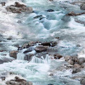 This detailed fabric features realistic water rapids flowing over river rocks. 