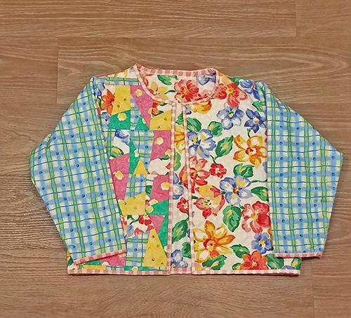 This darling quilted one of a kind jacket (front sidein florals and pastels will definitely make a statement! Available at Colorado Creations Quilting