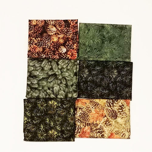 This bundle of fat quarters features a selection of pine cones and evergreen boughs.