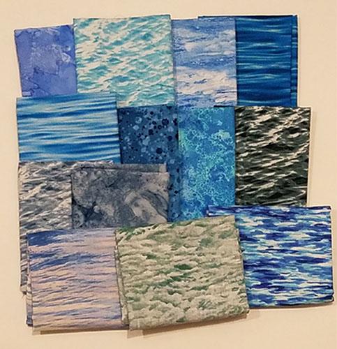 This fat quarter bundle has a selection of water cotton fabrics in bright blues and some with waves!