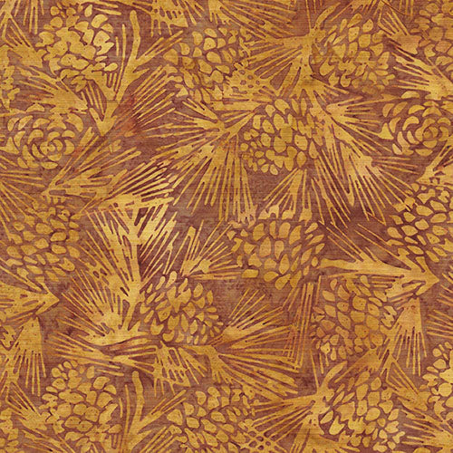 This batik fabric features pine cones on a rich golden background.

