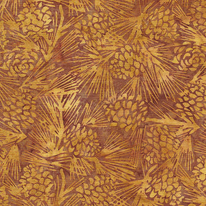 This batik fabric features pine cones on a rich golden background.
